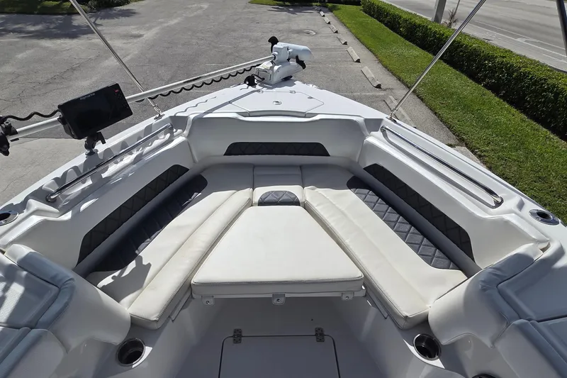 Slide: The Image of 2020 Blue Wave 2800 Makaira boat interior with cushioned seating and navigation equipment. - 14