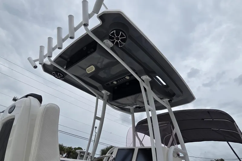 Slide: The Image of 2020 Blue Wave 2800 Makaira boat with T-top and rod holders under cloudy sky. - 16