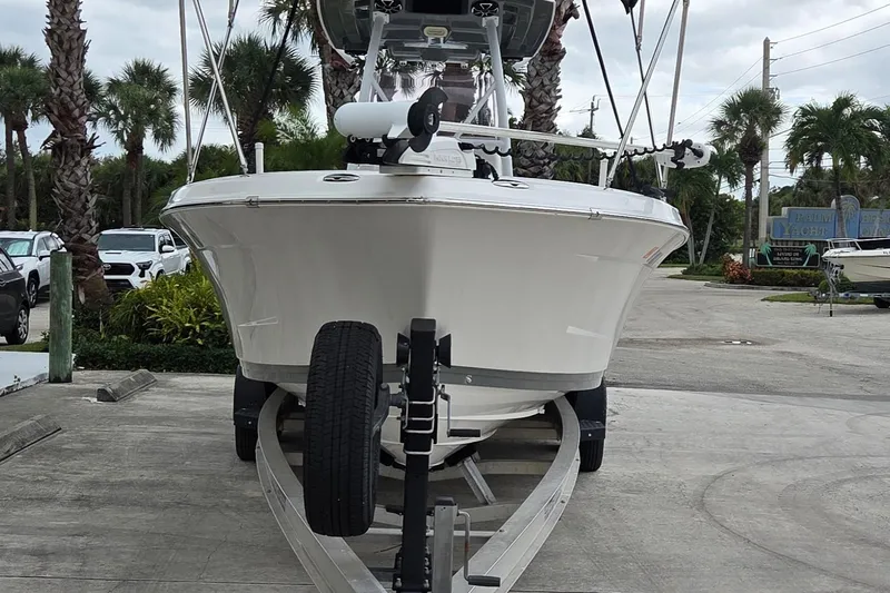 Slide: The Image of 2020 Blue Wave 2800 Makaira boat on trailer, surrounded by palm trees. - 2