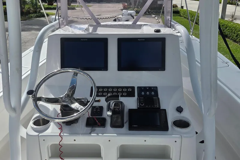 Slide: The Image of 2020 Blue Wave 2800 Makaira boat dashboard with dual screens and steering wheel. - 20