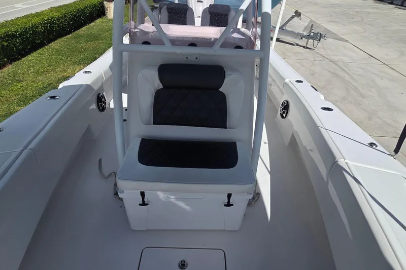 Slide: The Image of 2020 Blue Wave 2800 Makaira boat interior with cushioned seating and storage. - 21