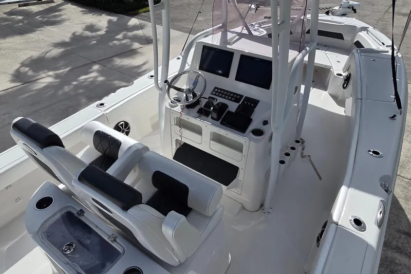 Slide: The Image of 2020 Blue Wave 2800 Makaira boat interior with dual seats and modern dashboard. - 7