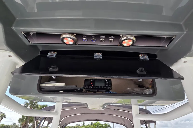 Slide: The Image of 2020 Blue Wave 2800 Makaira boat console with open storage and control panel. - 9