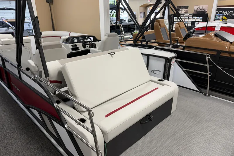 Slide: The Image of 2026 Crest Conquest 230 SLSC pontoon boat interior with white seating and modern dashboard. - 10