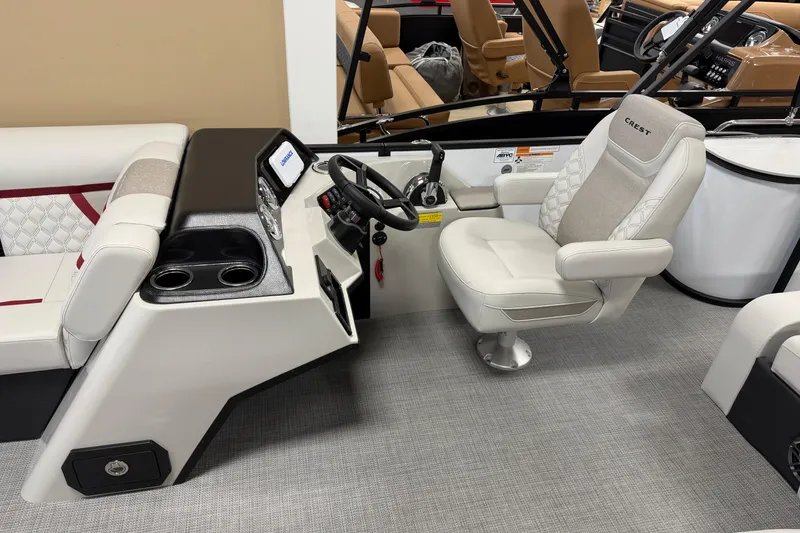 Slide: The Image of 2026 Crest Conquest 230 SLSC boat interior with captain's chair and control panel. - 4