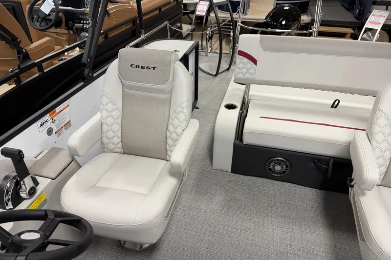 Slide: The Image of 2026 Crest Conquest 230 SLSC boat interior with plush seating and modern steering console. - 8