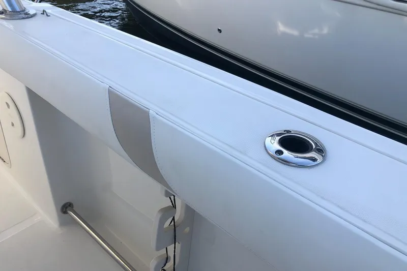 Slide: The Image of 2009 Boston Whaler 320 Outrage Cuddy Cabin interior detail with rod holder. - 12