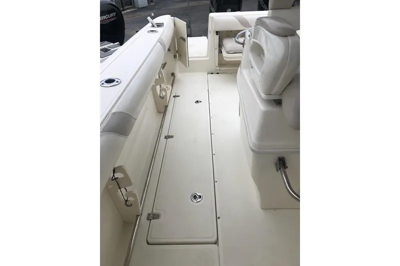 Slide: The Image of 2009 Boston Whaler 320 Outrage Cuddy Cabin interior with seating and storage. - 13