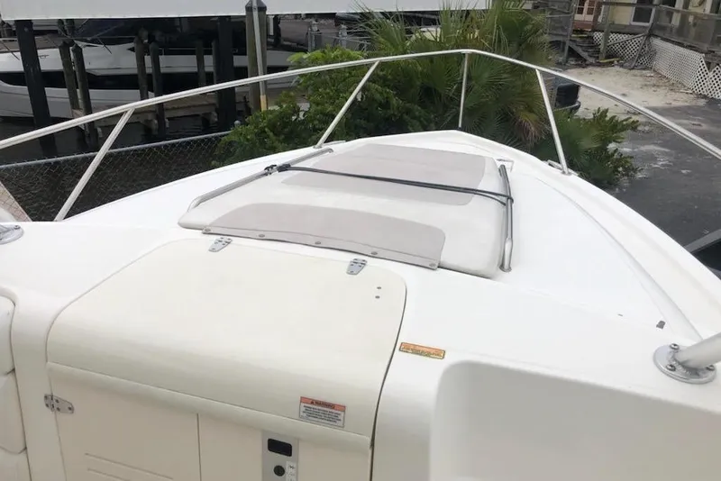 Slide: The Image of 2009 Boston Whaler 320 Outrage Cuddy Cabin boat deck, featuring sleek design and railing. - 14
