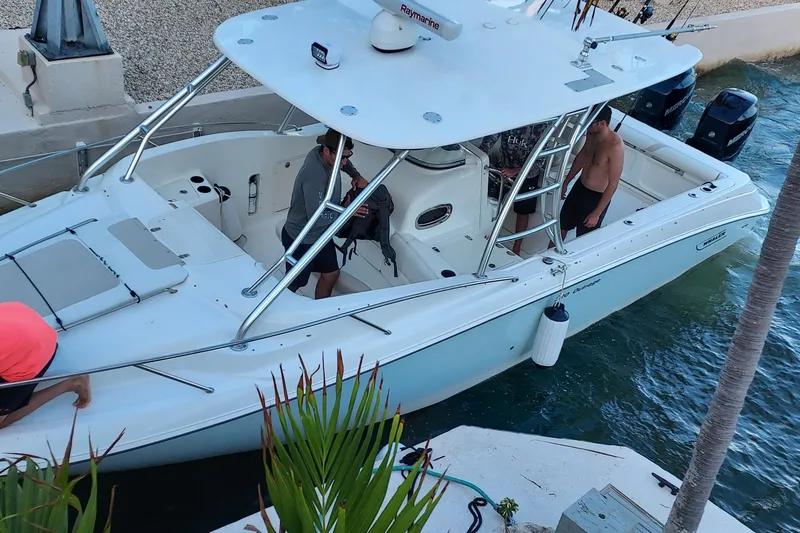Slide: The Image of 2009 Boston Whaler 320 Outrage Cuddy Cabin boat docked at marina under clear skies. - 2