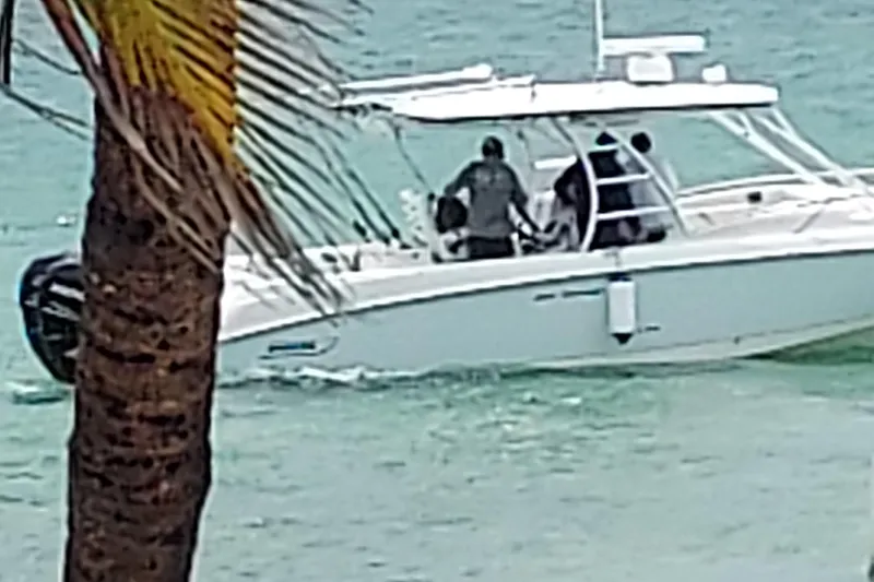 Slide: The Image of 2009 Boston Whaler 320 Outrage Cuddy Cabin docked at marina, showcasing sleek design. - 3