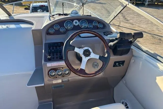 Slide: The Image of 2002 Regal Commodore 2765 boat dashboard with steering wheel and instrument panel. - 12