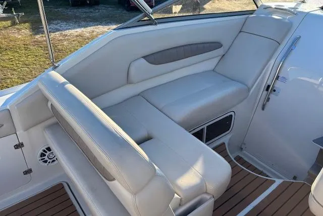 Slide: The Image of 2002 Regal Commodore 2765 boat interior with white leather seating and wood flooring. - 13