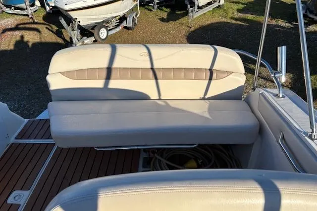 Slide: The Image of 2002 Regal Commodore 2765 boat interior with beige seating and wooden deck. - 14