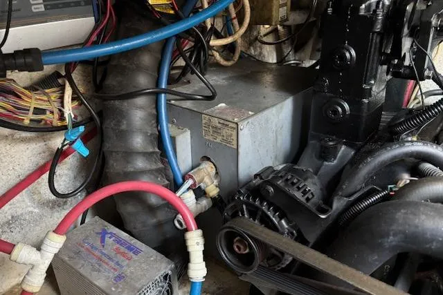 Slide: The Image of Engine compartment of a 2002 Regal Commodore 2765 boat, showing wiring and mechanical components. - 19