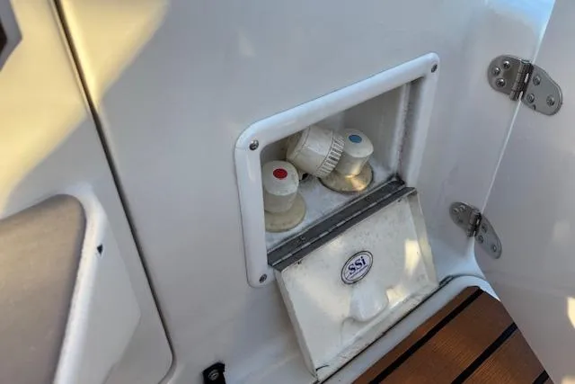 Slide: The Image of 2002 Regal Commodore 2765 boat shower controls with hot and cold water knobs. - 21