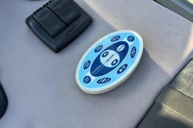 Slide: The Image of Remote control on a 2002 Regal Commodore 2765 boat dashboard. - 23