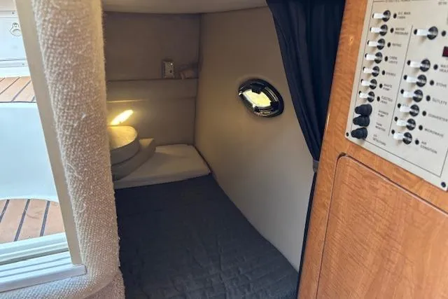 Slide: The Image of 2002 Regal Commodore 2765 cabin interior with cozy sleeping area and control panel. - 26