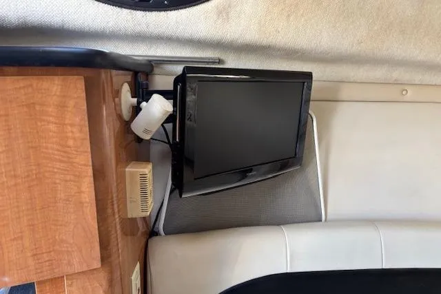 Slide: The Image of Interior of 2002 Regal Commodore 2765 boat with mounted TV and wooden cabinetry. - 31