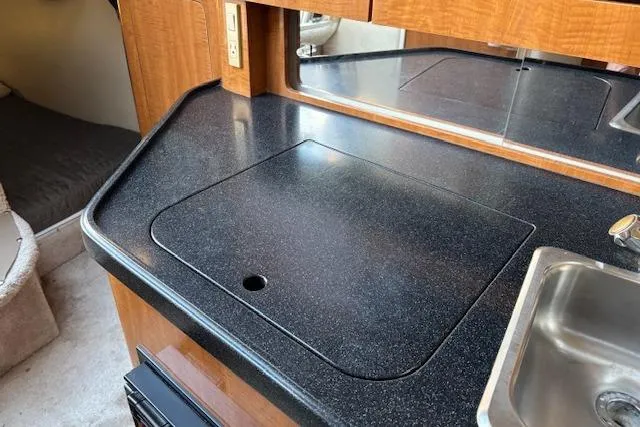 Slide: The Image of 2002 Regal Commodore 2765 boat interior with kitchenette and sink. - 32