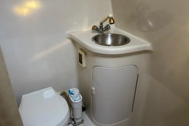 Slide: The Image of 2002 Regal Commodore 2765 boat bathroom with compact sink and toilet. - 33
