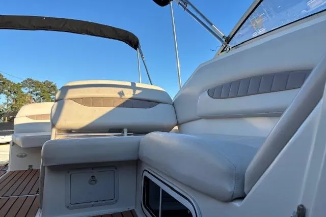 Slide: The Image of 2002 Regal Commodore 2765 boat interior with cushioned seating and wooden deck. - 34