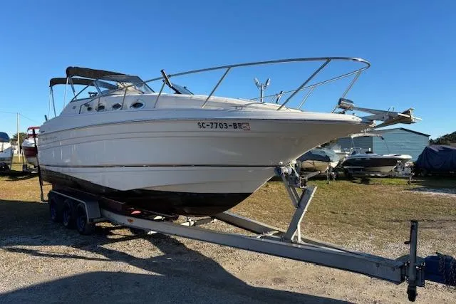 Slide: The Image of 2002 Regal Commodore 2765 boat on trailer under clear blue sky. - 4