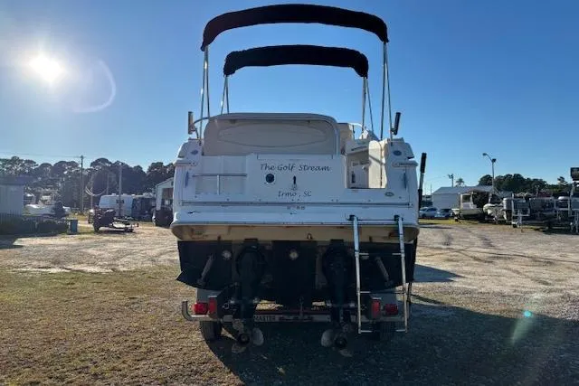 Slide: The Image of 2002 Regal Commodore 2765 boat, rear view, parked outdoors under clear blue sky. - 7