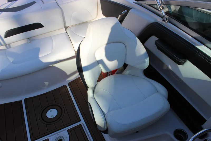 Slide: The Image of 2017 Chaparral 21 H2O Ski & Fish boat interior with white seating and wood flooring. - 10