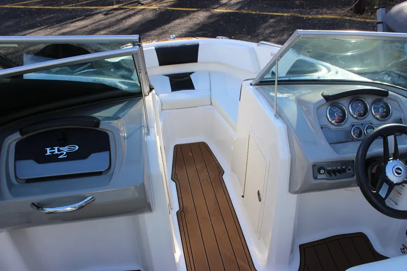 Slide: The Image of 2017 Chaparral 21 H2O Ski & Fish boat interior with dashboard and seating. - 12