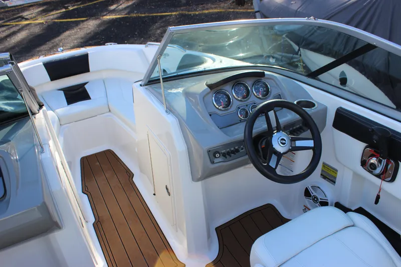 Slide: The Image of 2017 Chaparral 21 H2O Ski & Fish boat interior with steering wheel and dashboard. - 13