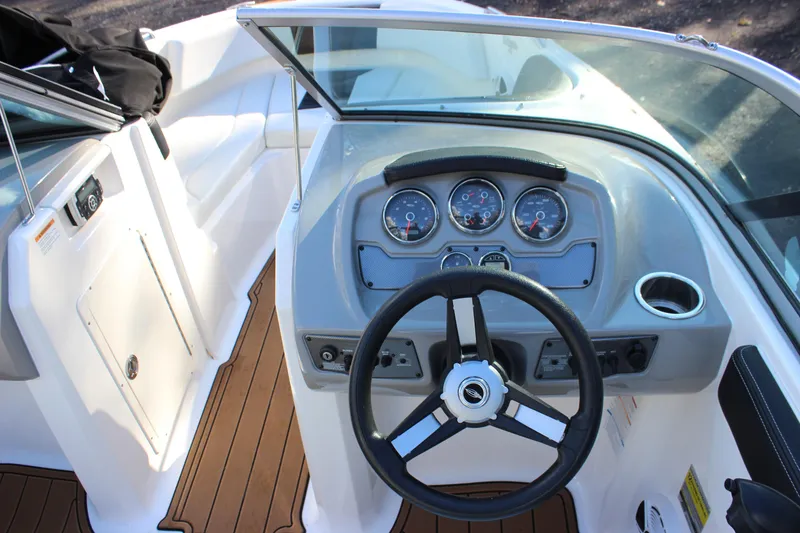 Slide: The Image of 2017 Chaparral 21 H2O Ski & Fish boat dashboard with steering wheel and gauges. - 14