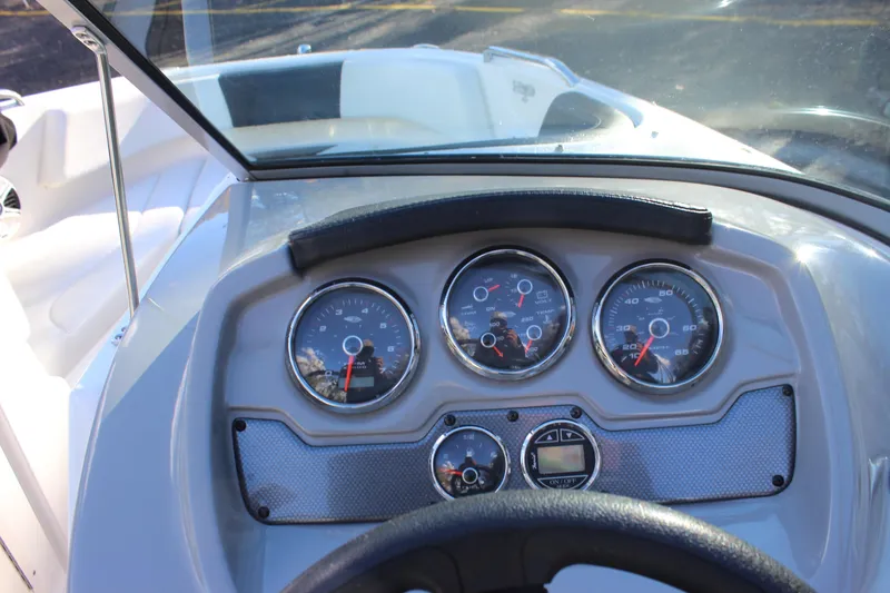 Slide: The Image of Dashboard of a 2017 Chaparral 21 H2O Ski & Fish boat with gauges and steering wheel. - 15
