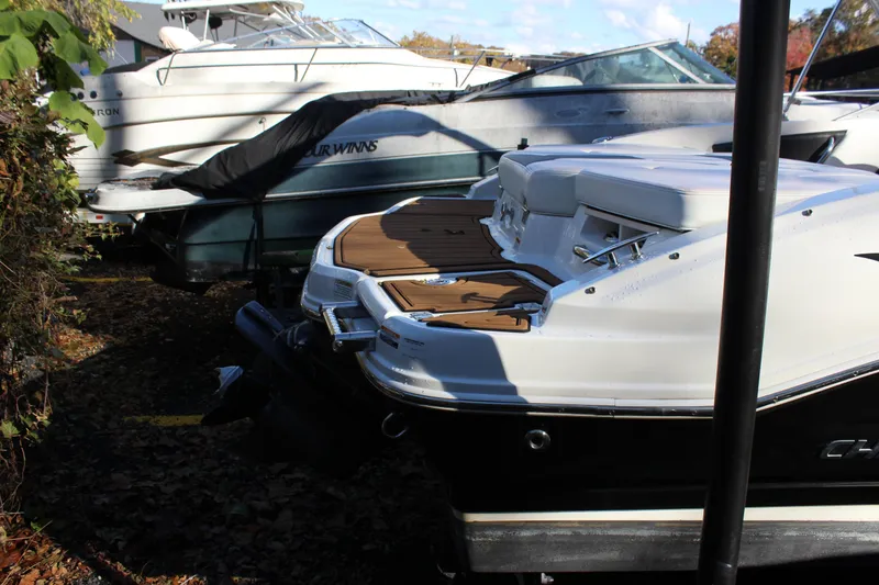 Slide: The Image of 2017 Chaparral 21 H2O Ski & Fish boat docked, surrounded by other boats. - 30