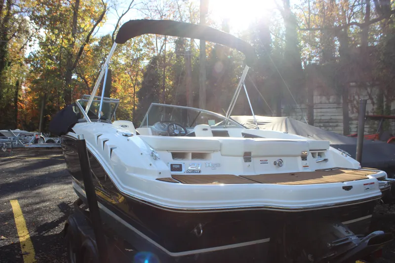 Slide: The Image of 2017 Chaparral 21 H2O Ski & Fish boat in a wooded area with sunlight. - 33