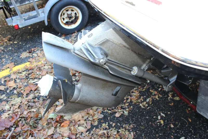 Slide: The Image of 2017 Chaparral 21 H2O Ski & Fish boat propeller and outdrive on a leaf-covered ground. - 35