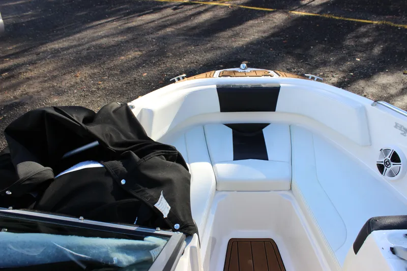 Slide: The Image of 2017 Chaparral 21 H2O Ski & Fish boat interior with white seating and black cover. - 5