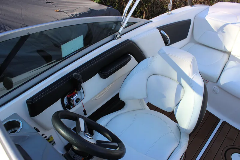 Slide: The Image of 2017 Chaparral 21 H2O Ski & Fish boat interior with steering wheel and seating. - 9