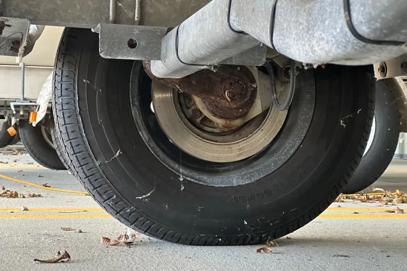 Slide: The Image of Close-up of a trailer wheel under a Grady-White Tournament 192 boat, 1995 model. - 12