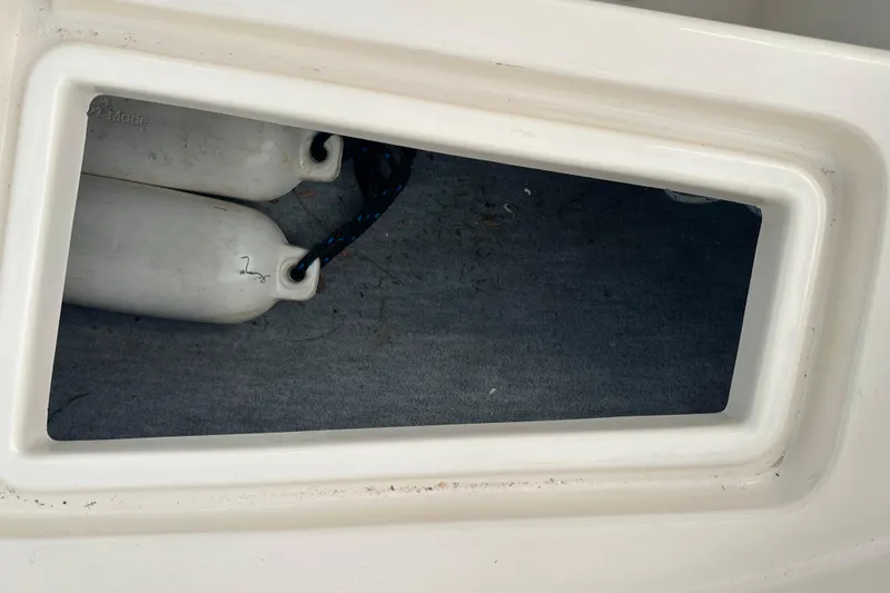 Slide: The Image of Storage compartment on a 1995 Grady-White Tournament 192 boat with fenders inside. - 17