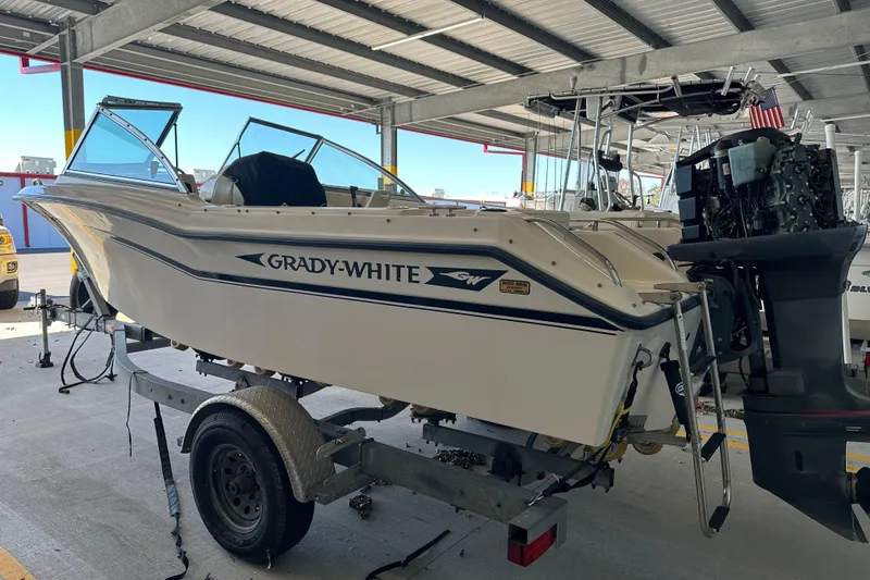 Slide: The Image of 1995 Grady-White Tournament 192 boat on trailer in covered storage area. - 2