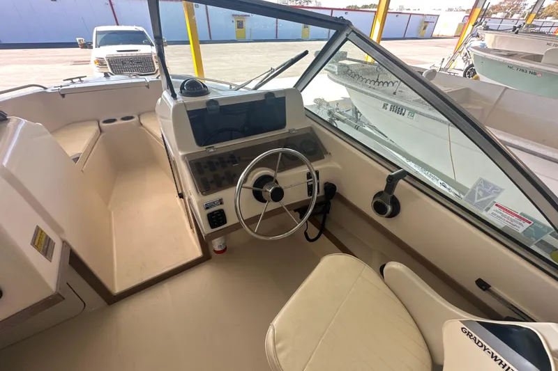 Slide: The Image of Interior view of a 1995 Grady-White Tournament 192 boat cockpit with steering wheel and controls. - 20