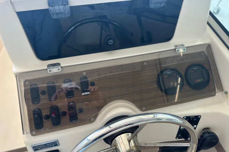Slide: The Image of 1995 Grady-White Tournament 192 boat dashboard with gauges and controls. - 21