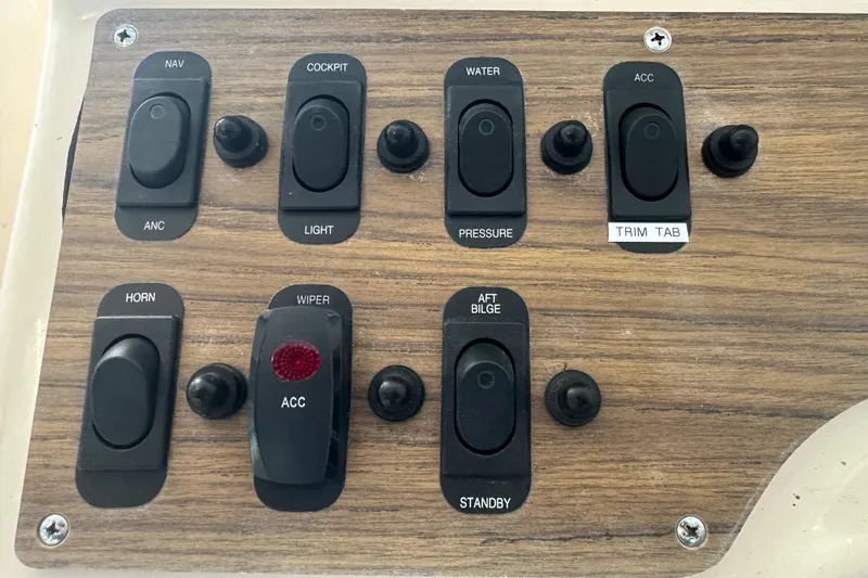 Slide: The Image of Control panel of a 1995 Grady-White Tournament 192 boat with various switches. - 23