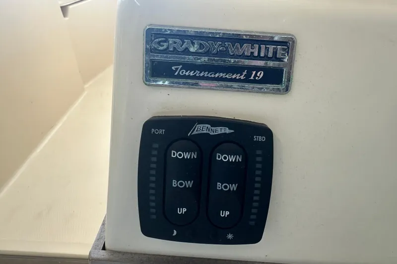 Slide: The Image of Control panel of a 1995 Grady-White Tournament 192 boat with trim tab switches. - 25