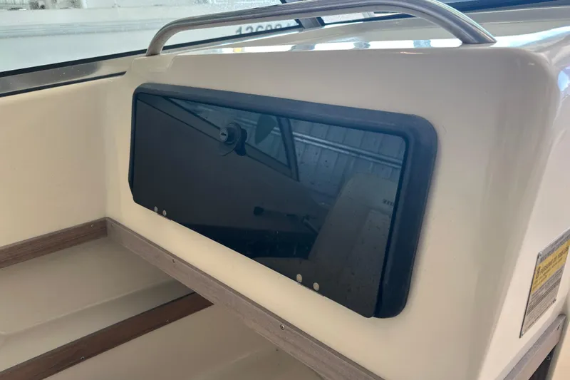 Slide: The Image of 1995 Grady-White Tournament 192 boat interior with storage compartment and railing. - 28