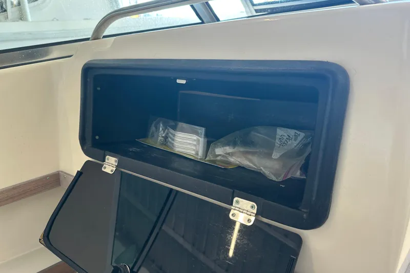 Slide: The Image of Storage compartment on a 1995 Grady-White Tournament 192 boat, containing various items. - 29