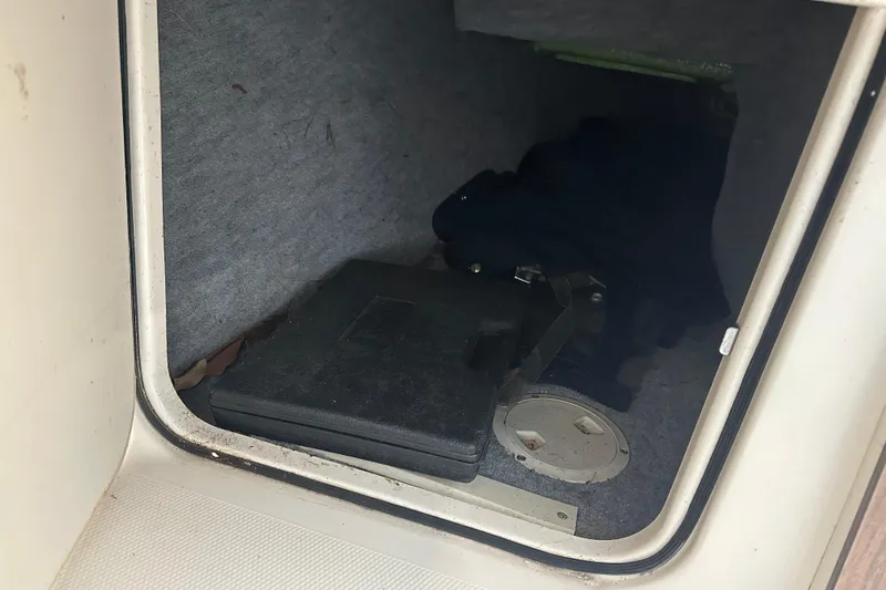 Slide: The Image of Storage compartment in a 1995 Grady-White Tournament 192 boat, featuring interior items. - 30