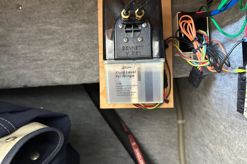 Slide: The Image of Bennett trim tab pump in 1995 Grady-White Tournament 192 boat, with wiring and fluid level indicator. - 32