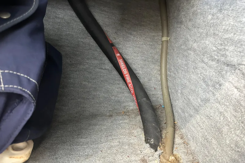 Slide: The Image of Interior of a 1995 Grady-White Tournament 192 boat showing cables and fabric lining. - 33